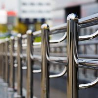 Chromium metal fence with handrail. Chrome-plated metal railings. Shallow depth of field. Selective focus.