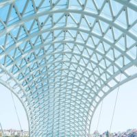 The Bridge of Peace is a bow-shaped pedestrian bridge, a steel and glass construction illuminated with numerous LEDs, over the Kura River in downtown Tbilisi, capital of Georgia.