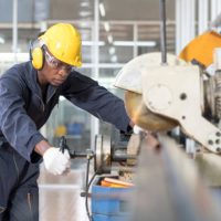 Engineer in a factory . Smart factory worker or engineer using machine job in a manufacturing workshop