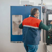 senior man working on cnc machine